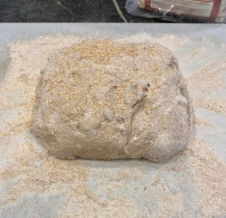 Coating the dough with a lot of flour and wheat germ